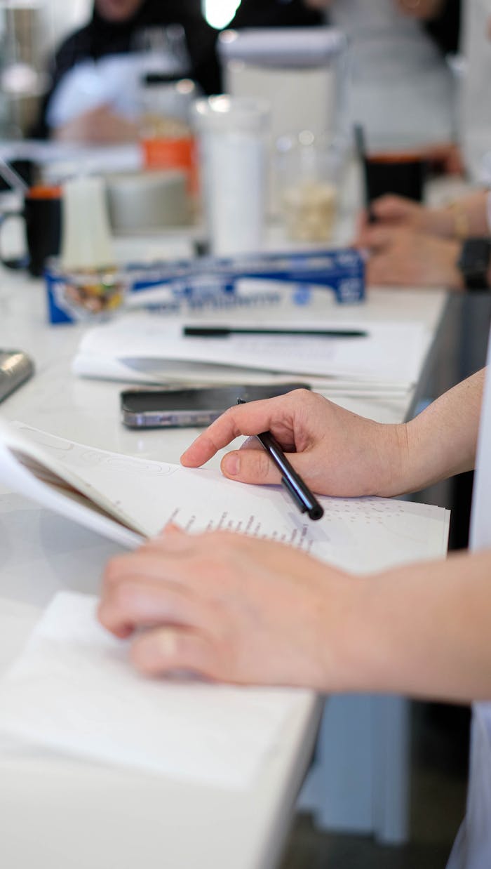 Close-up of people working and writing in a busy office setting in Chicago.